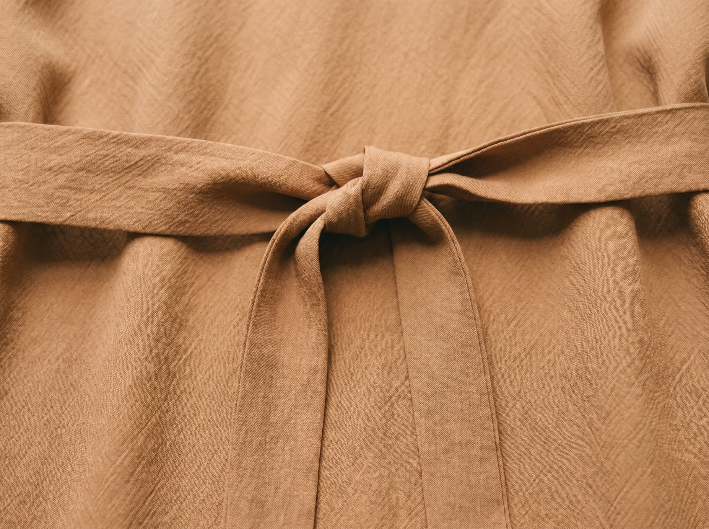 The belt of the Oudaya robe in Amande, cut on the bias and tied flat.