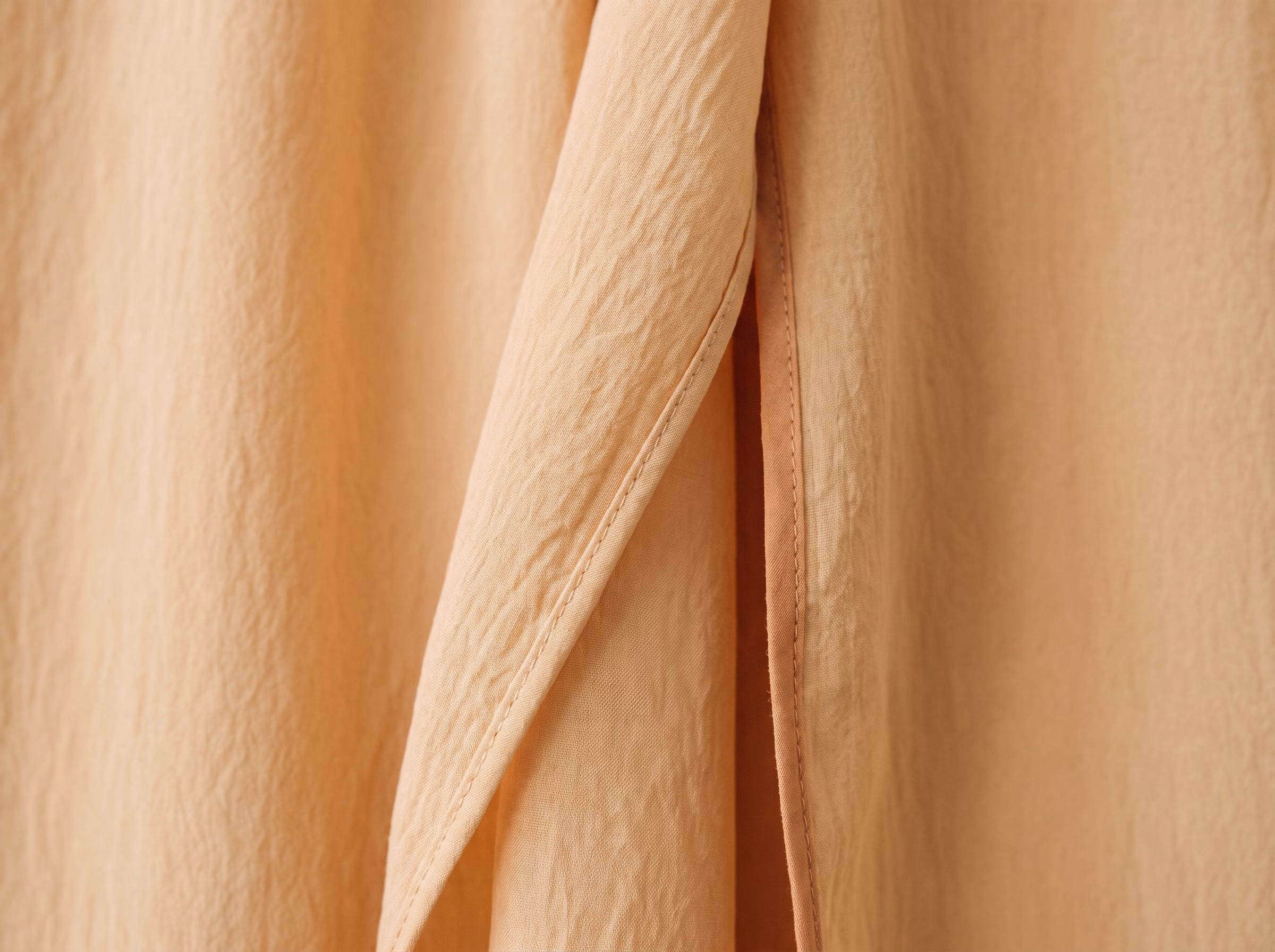 The rolled hem of the Oudaya robe in Amande, and the lining seam.